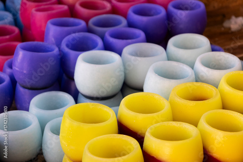 handmade candles of different colors in a traditional market
