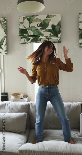 Happy beautiful Hispanic woman having fun at cozy home