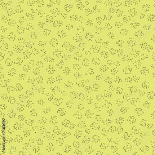 A yellow background with a repeating pattern of small black floral shapes scattered across it.