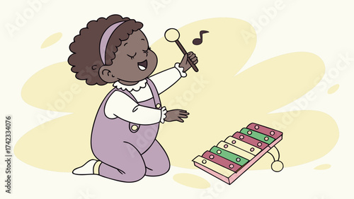 Baby with afro playing a xylophone with joyful expression