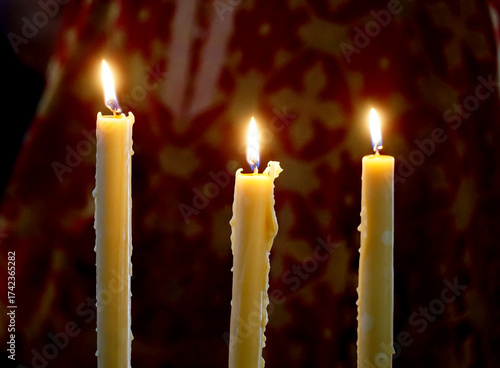 three orthodox candles in an orthodox church