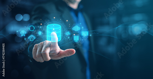 Businessman touching futuristic database with digital data waves, cloud computing, big data analytics, and cybersecurity concept for technology, IT innovation, and digital transformation.