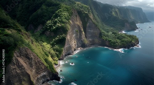 Breathtaking aerial vista of dramatic verdant cliffs meeting the azure ocean, showcasing a majestic and rugged tropical coastline under an atmospheric sky