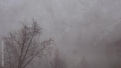 Snowstorm outside the window. Snow fog from blizzard.
