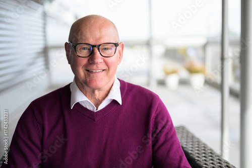 Portrait of a senior man with eyeglasses smiling at the camera