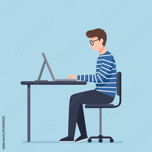 Person in striped shirt works on laptop at desk
