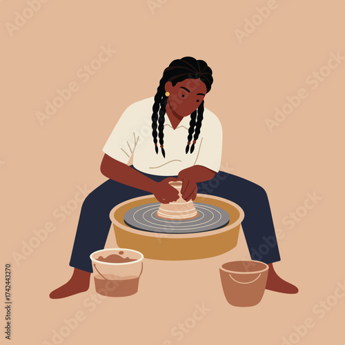 Focused person crafting clay on a pottery wheel with two buckets beside them