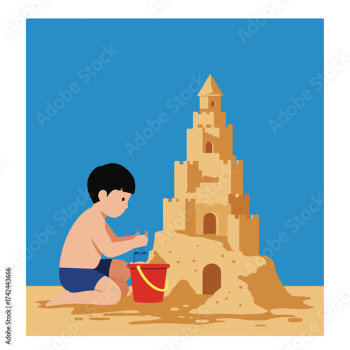 Child builds an elaborate sandcastle on a beach next to a red bucket