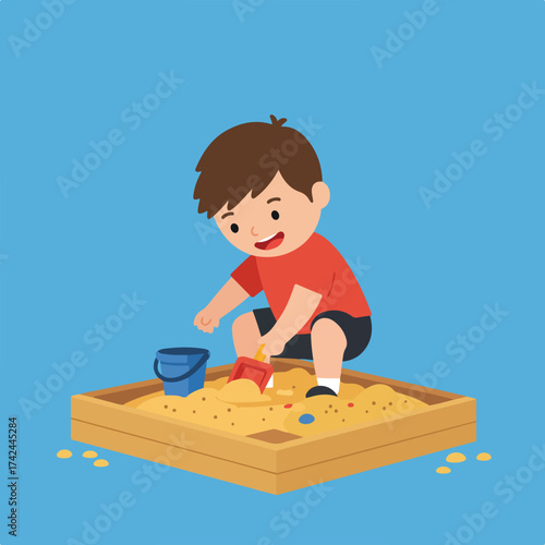 Young boy happily playing in a sandbox with toys