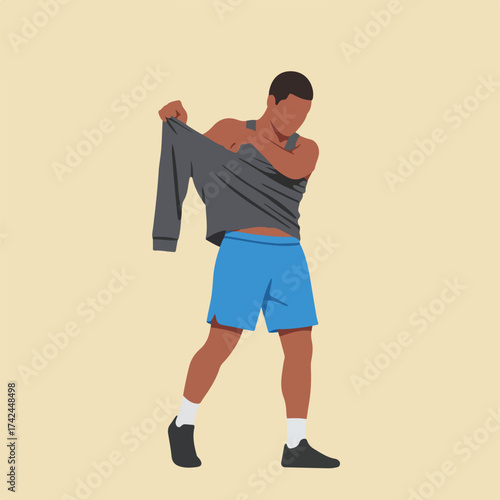 Person in blue shorts and grey shirt, pulling off shirt