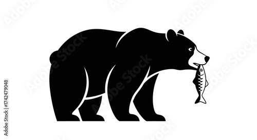 Black bear silhouette walking with a fish in its mouth.