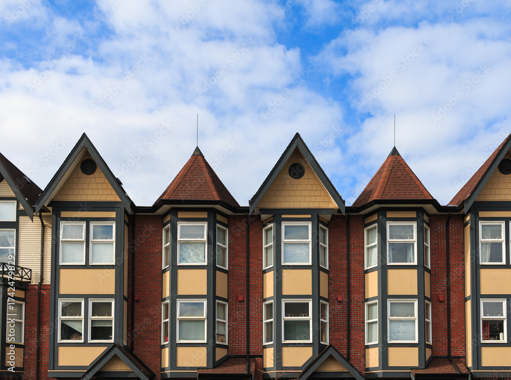 Fototapeta premium Beautiful vintage stile architecture with charming gables under a blue sky in an urban setting during daytime hours