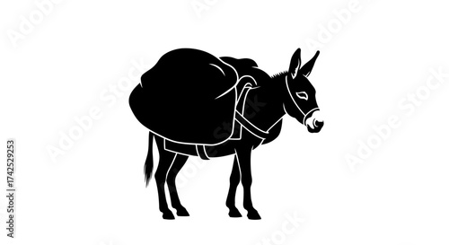 Silhouette of a donkey carrying a large load on its back.