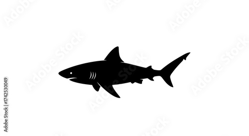 Black silhouette of a powerful shark swimming.