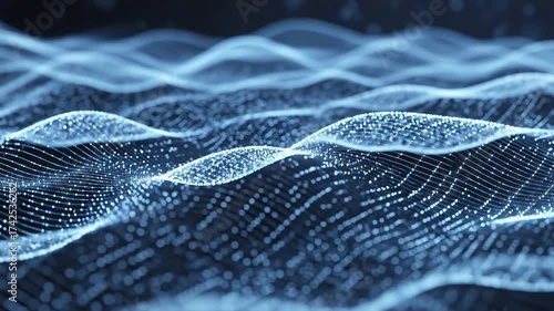 Glowing blue particles form undulating waves against a dark background with a shallow depth of field