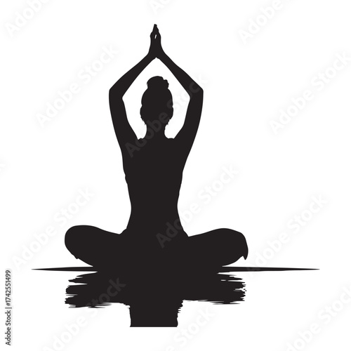 Silhouette of woman practicing yoga in lotus position with reflection