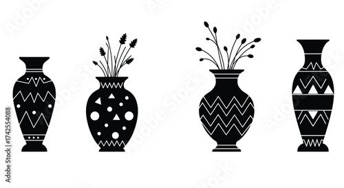 A collection of four black and white decorative vases with floral arrangements