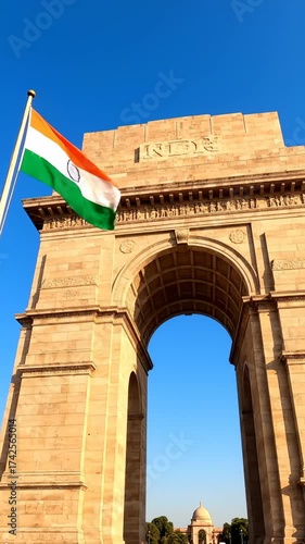 India Gate Arch and Indian Flag Waving on a Sunny Day, New Delhi