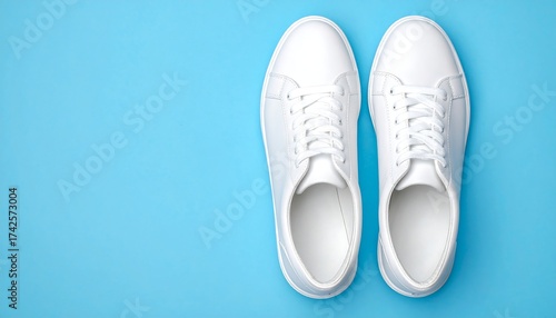 Wallpaper Mural Two bright white sneakers arranged on a vibrant, pale blue background Torontodigital.ca