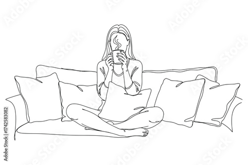 Vector art of woman sitting crosslegged on a sofa with pillows, holding a mug