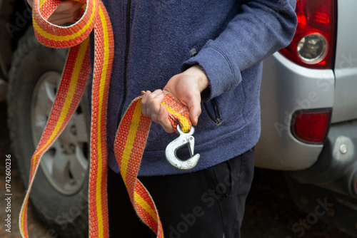 A cable for pulling a stuck car and towing a car.