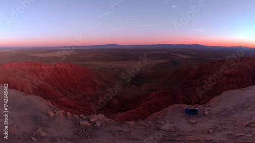 Twilight desert scene glowing with warm tones as meteors streak through sky