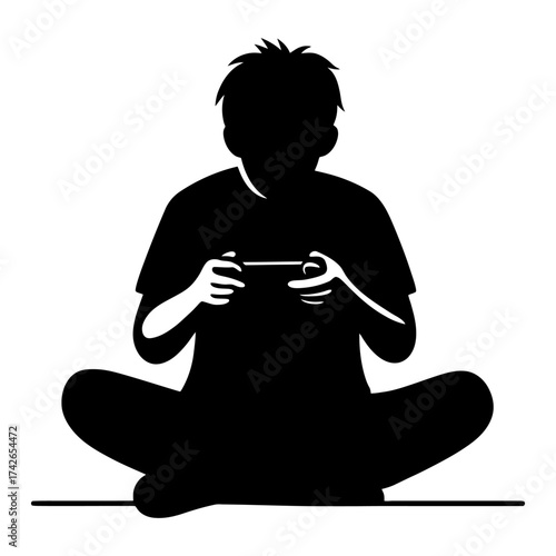 A boy is sitting on the floor playing a video game. He is holding a controller in his hands. Vector. Silhouette illustration.