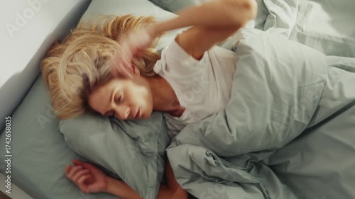 Frustrated Woman Hitting Pillow in Bed After Sleepless Night