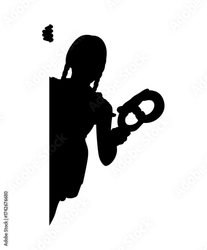 Silhouette of a young girl holding a pretzel and looking down at it with a thoughtful expression