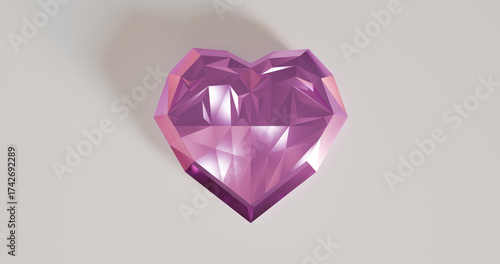 Pink diamond shaped heart shining on a white surface with light reflecting from all sides