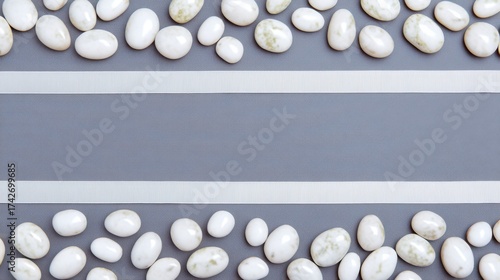 Decorative White Pebbles and Ribbons on a Gray Surface Background