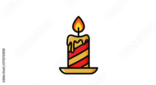 Festive candle with striped design and warm glow on plate