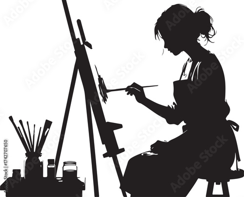 Silhouette of woman painting on easel with art supplies