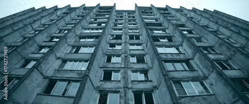 Soviet-style apartment building facade with symmetrical windows and concrete texture