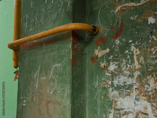 yellow gas pipe with a crane goes along the facade of a new multi-storey building. House connected to gas for domestic use