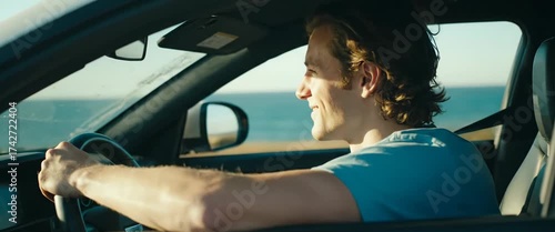 Young man driving by the ocean at sunset: serene coastal journey
