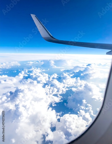 View from an aircraft window blue sky, clouds, and wingtip