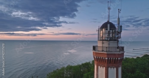 Beautiful lighthouse at sunset in Rewal at Baltic Sea.