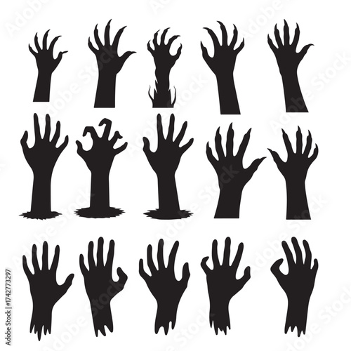 Collection of spooky silhouetted zombie hands reaching upward from the ground silhouette