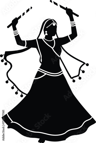 Silhouette of a woman in traditional indian attire performing garba dance with dandiya sticks