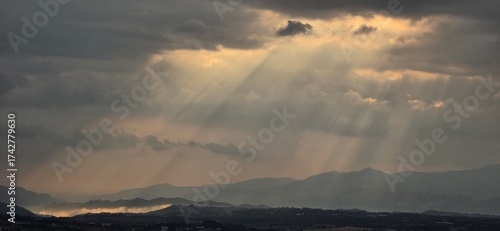 Sun Rays Through Storm Clouds Over Hillsin Costa Rica
