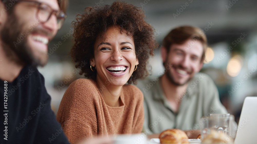 Fototapeta premium Joyful meeting with friends. A diverse group laughing together at a cafe. Captures connection, friendship, and positive vibes. Great for social, lifestyle business themes.