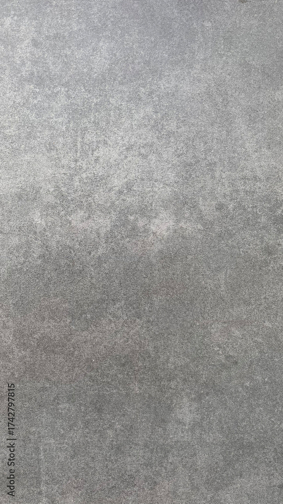 Fototapeta premium Gray textured surface showing subtle patterns suitable for various artistic and architectural uses