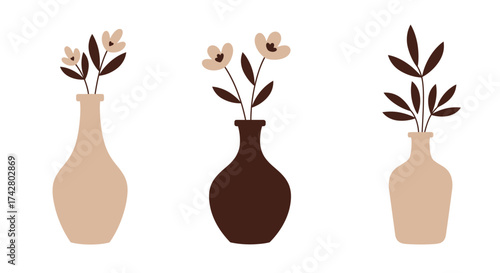 Simple floral arrangement with three vases in muted earthy tones