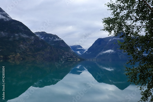reflection of the sky and mountains in the water - Stryn, Norway