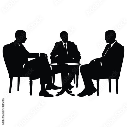 Silhouetted business executives sit around small table discussing strategy and planning together