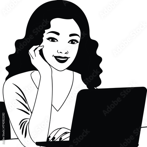 Smiling Asian woman working intently on her laptop with focused expression in black and white