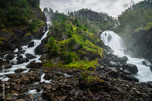 låtefossen Lattefossen waterfall in norway during rainday cold waterflow river long exposure