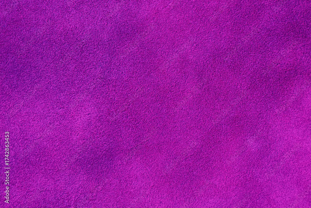 Fototapeta premium Suede background of purple color. Macro photo of suede genuine leather of purple color.
