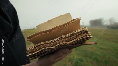 Book With Holy Scriptures Read By A Man In A Foggy Winter Park